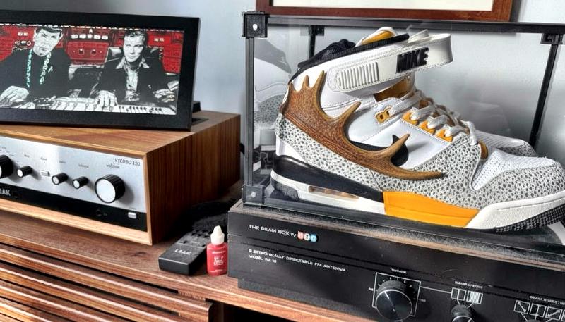 A pair of Nike Air Revolutions in a display case with antlers on the sides of the shoes